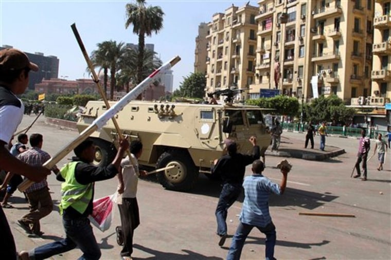 Protesters challenge a military vehicle Monday during an operation to clear protesters from camping out in Tahrir Square in Cairo, Egypt.